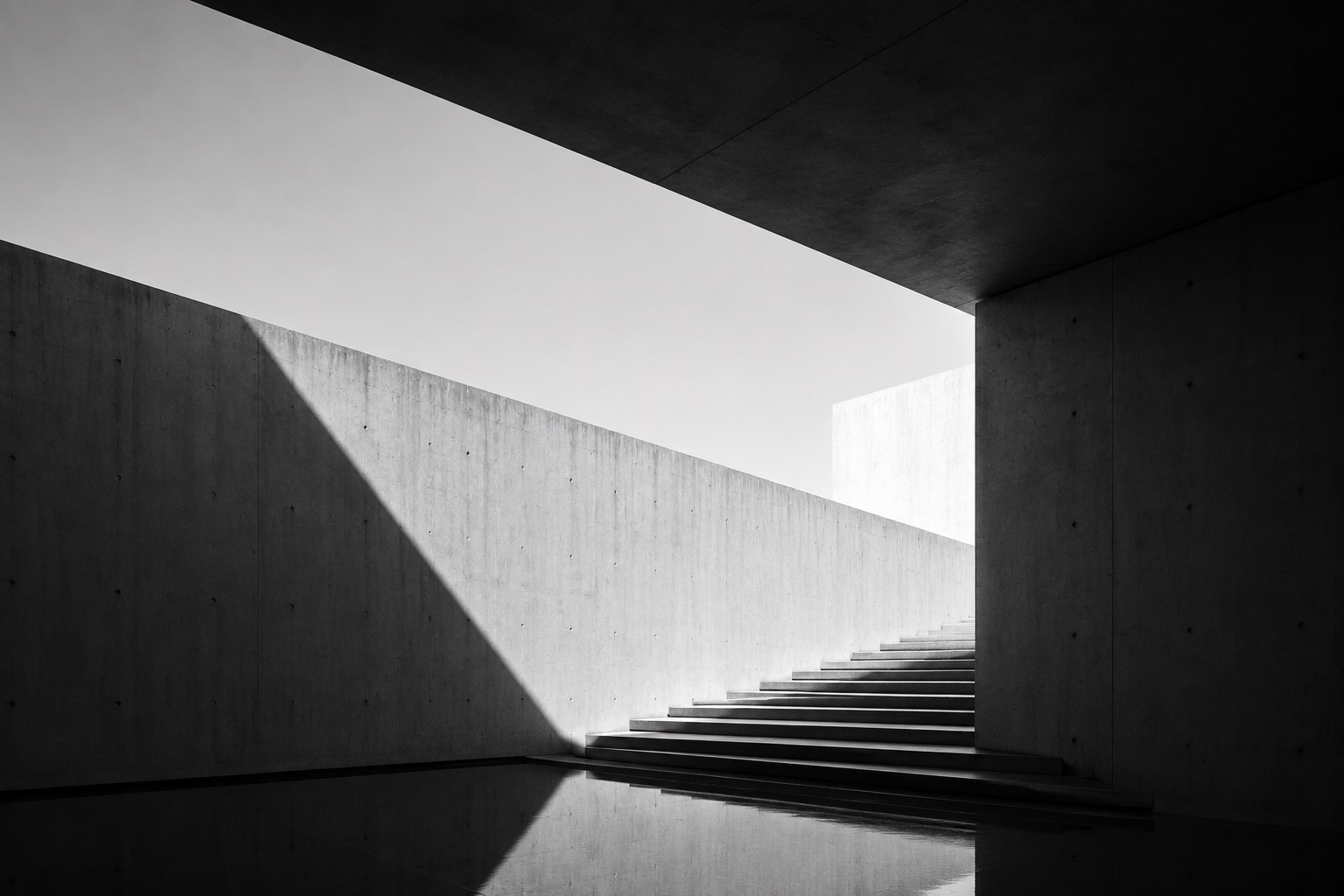 Concrete stairs ascending toward light